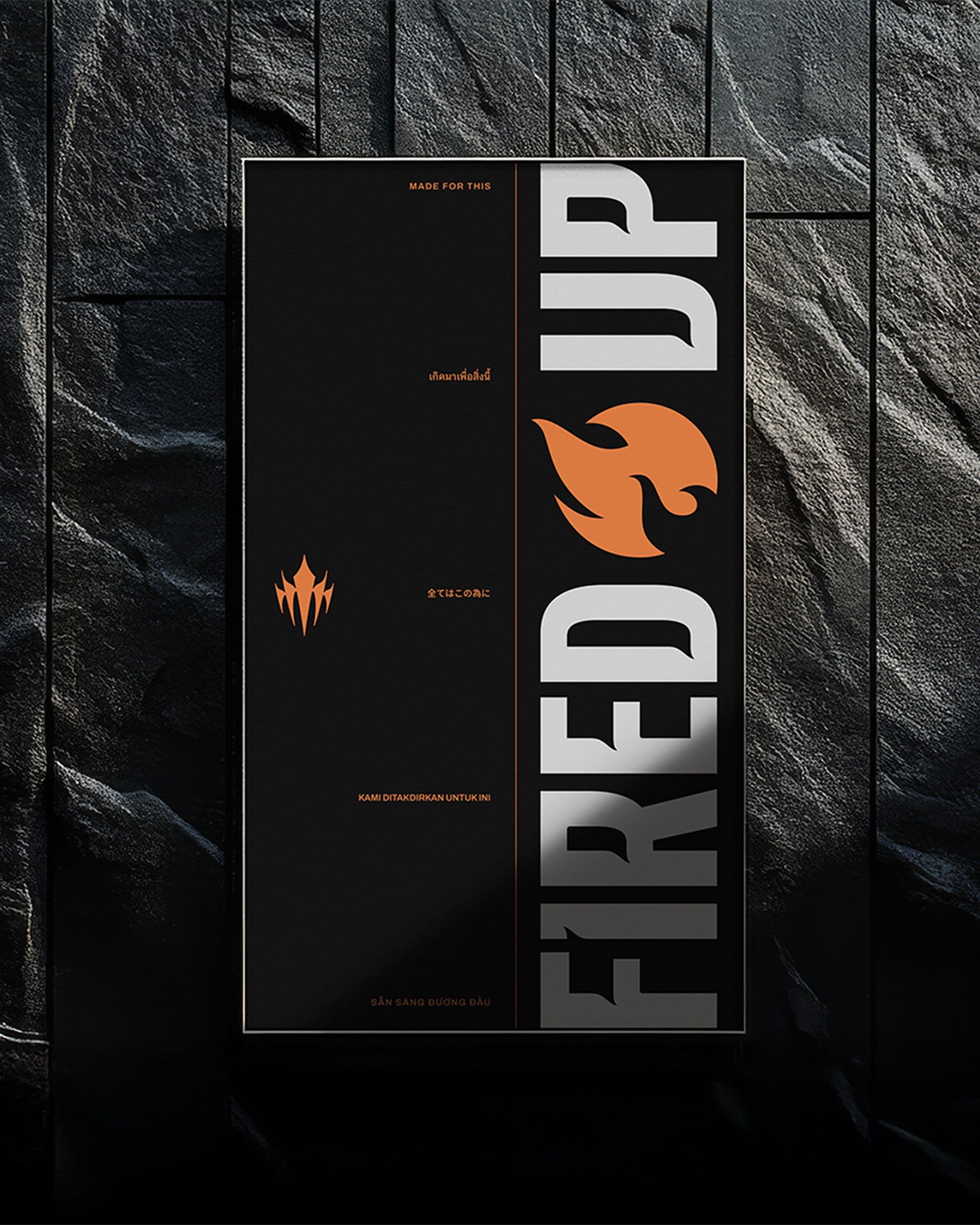 A poster with FIRED UP in large gray letters, featuring an orange flame icon. Smaller text includes phrases like MADE FOR THIS and other lines in different languages.