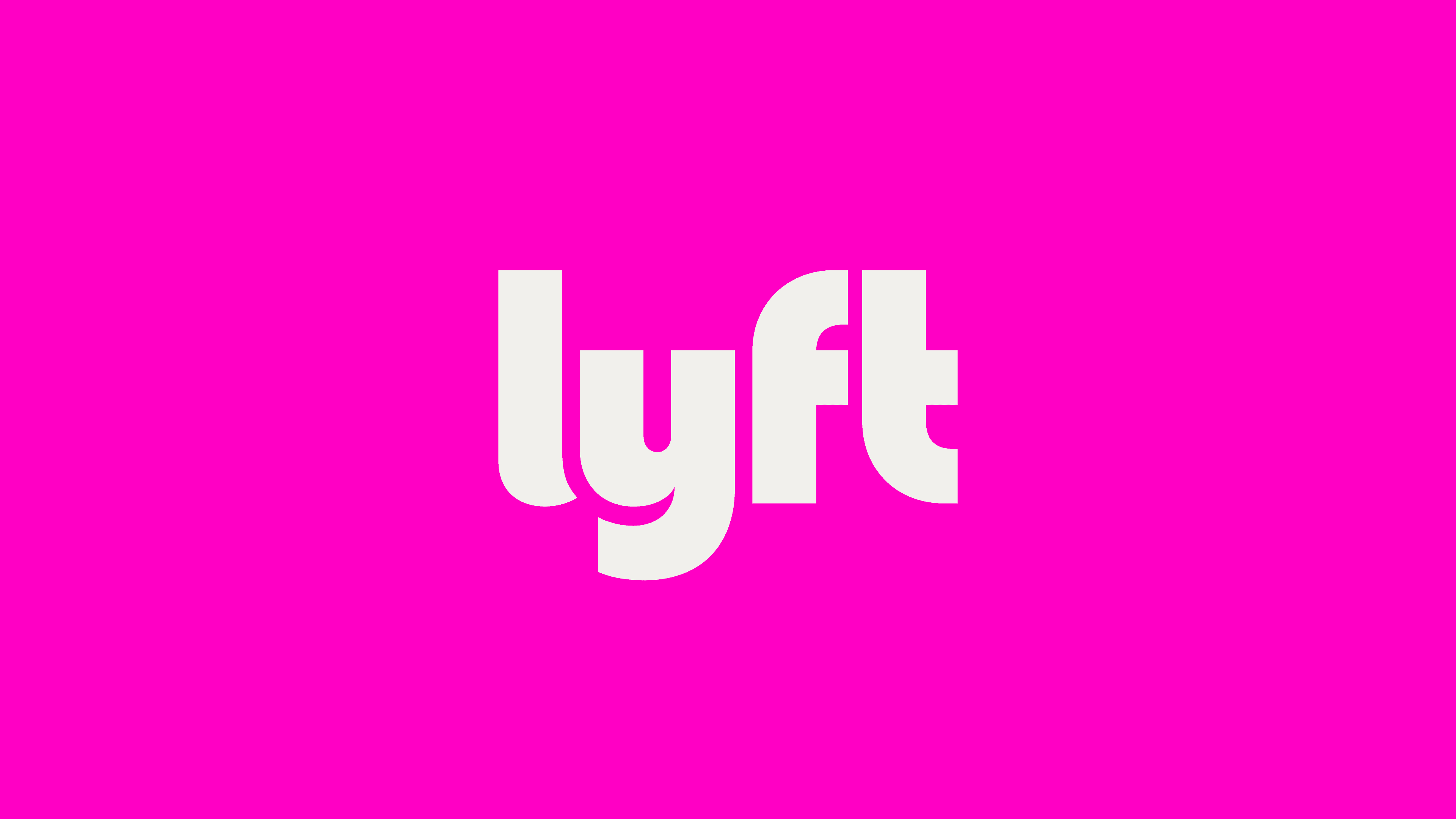 The image shows the white lyft logo in lowercase letters centered on a bright pink background.