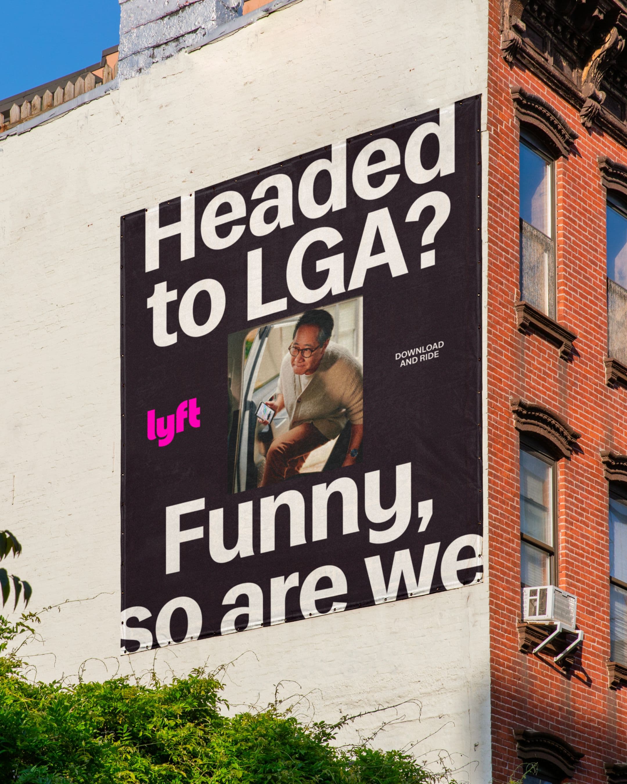 A large Lyft advertisement on a building wall.