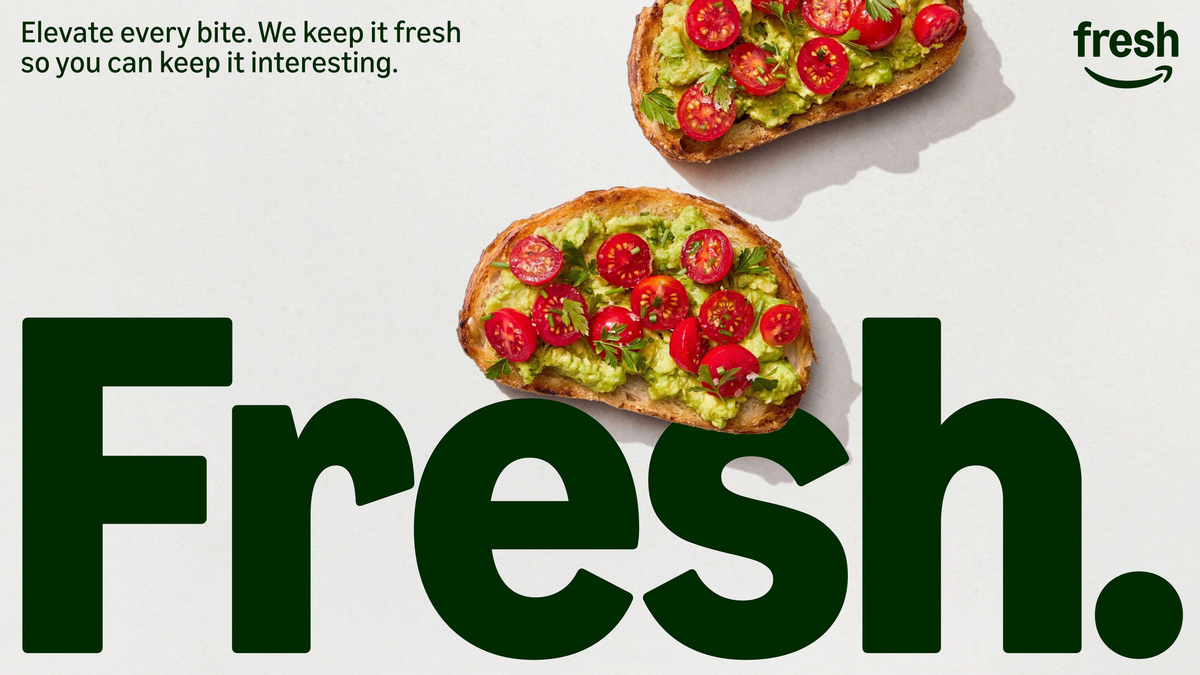 Two slices of toast topped with avocado and cherry tomatoes sit above the large bold word Fresh. Promotional text in the top left reads, Elevate every bite. We keep it fresh so you can keep it interesting.