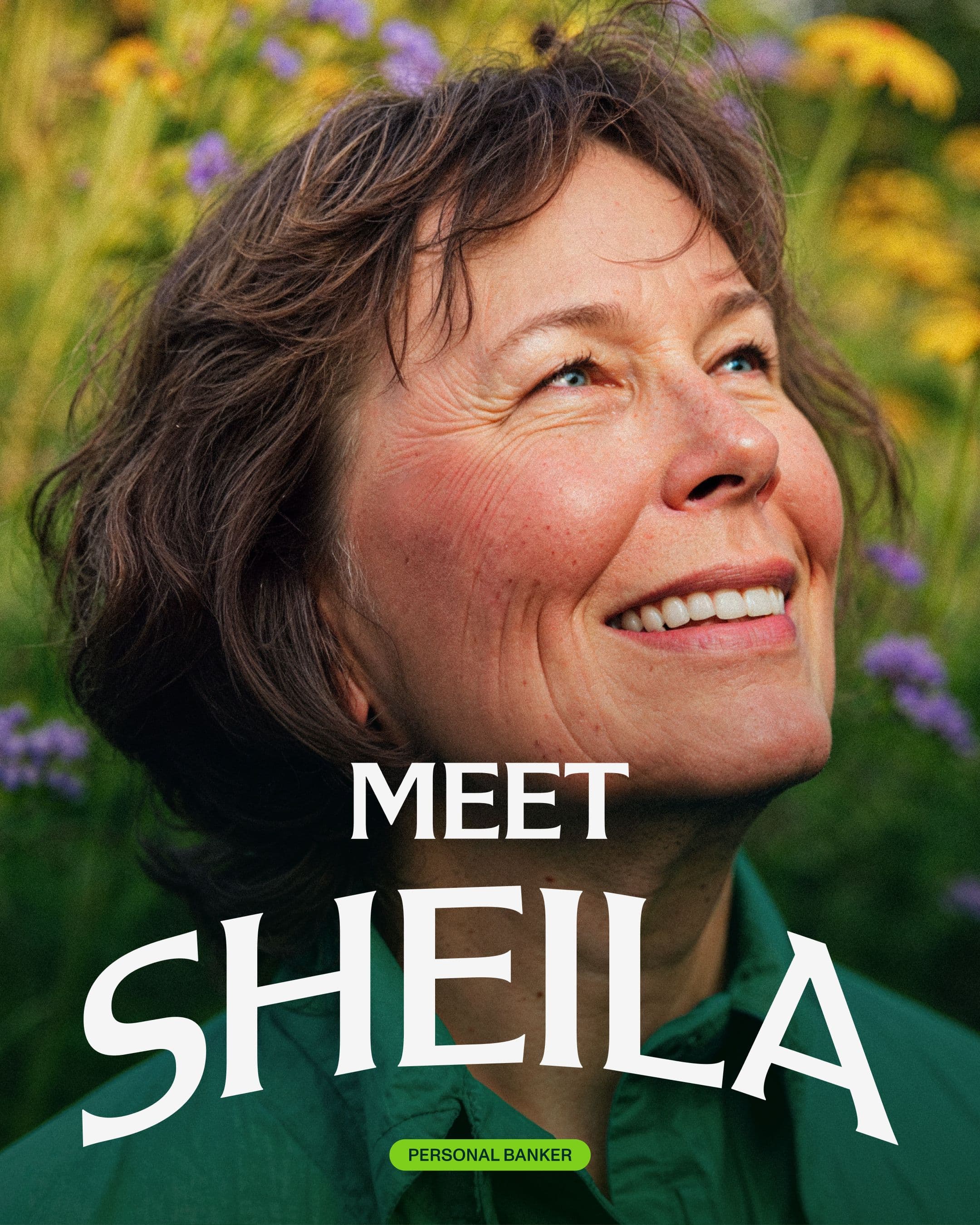 A woman with short brown hair smiles and looks upward, standing outdoors among green plants and yellow flowers. The text on the image reads, MEET SHEILA and PERSONAL BANKER.