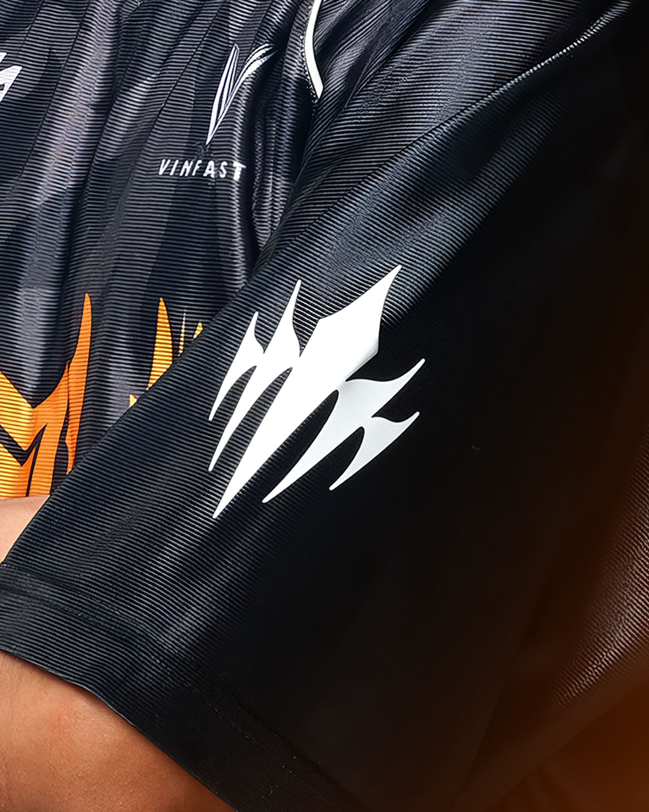 A close-up of a the Riot LCP logo on the sleeve of a shirt.