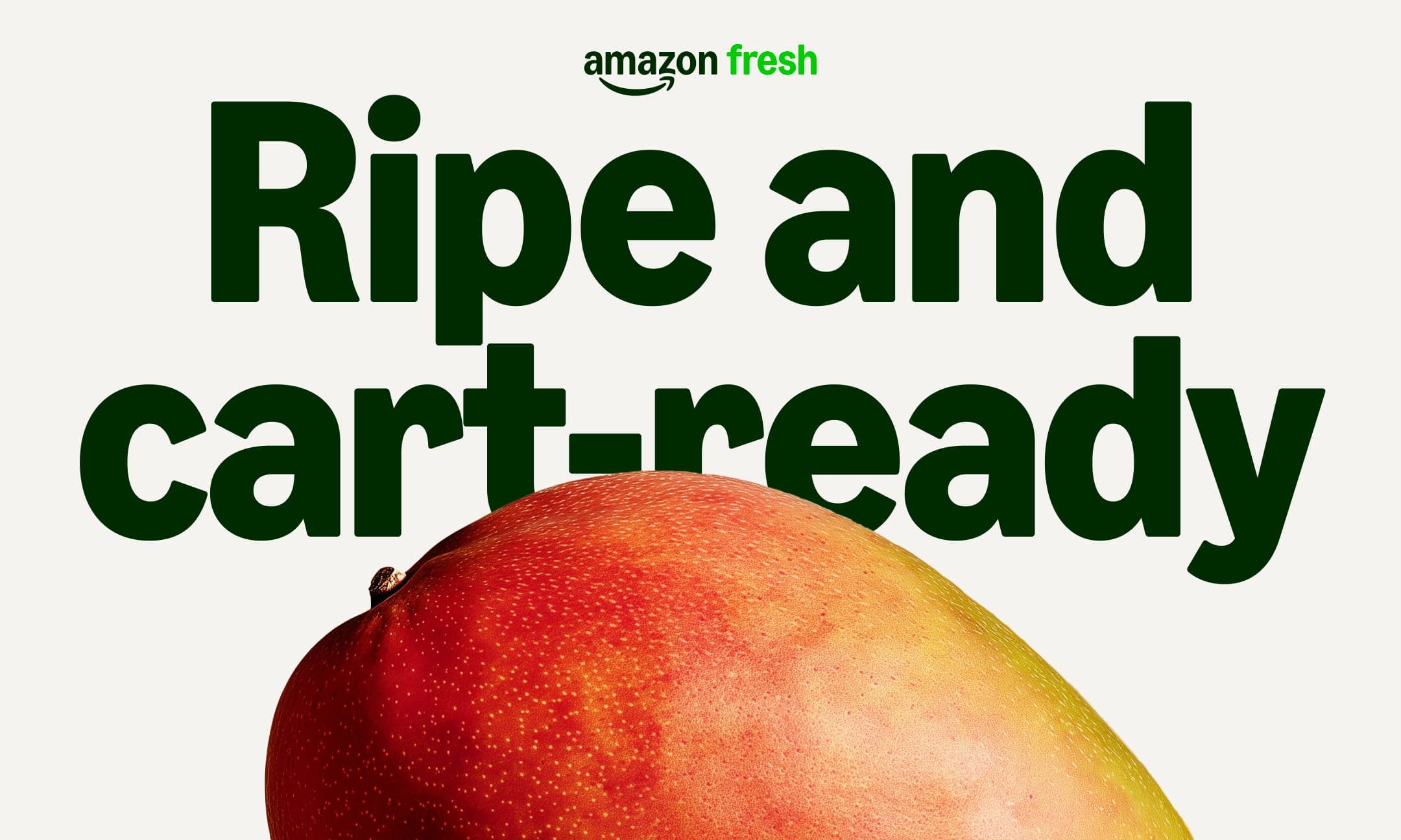 A ripe mango in front of bold green text that reads Ripe and cart-ready with the Amazon Fresh logo above.