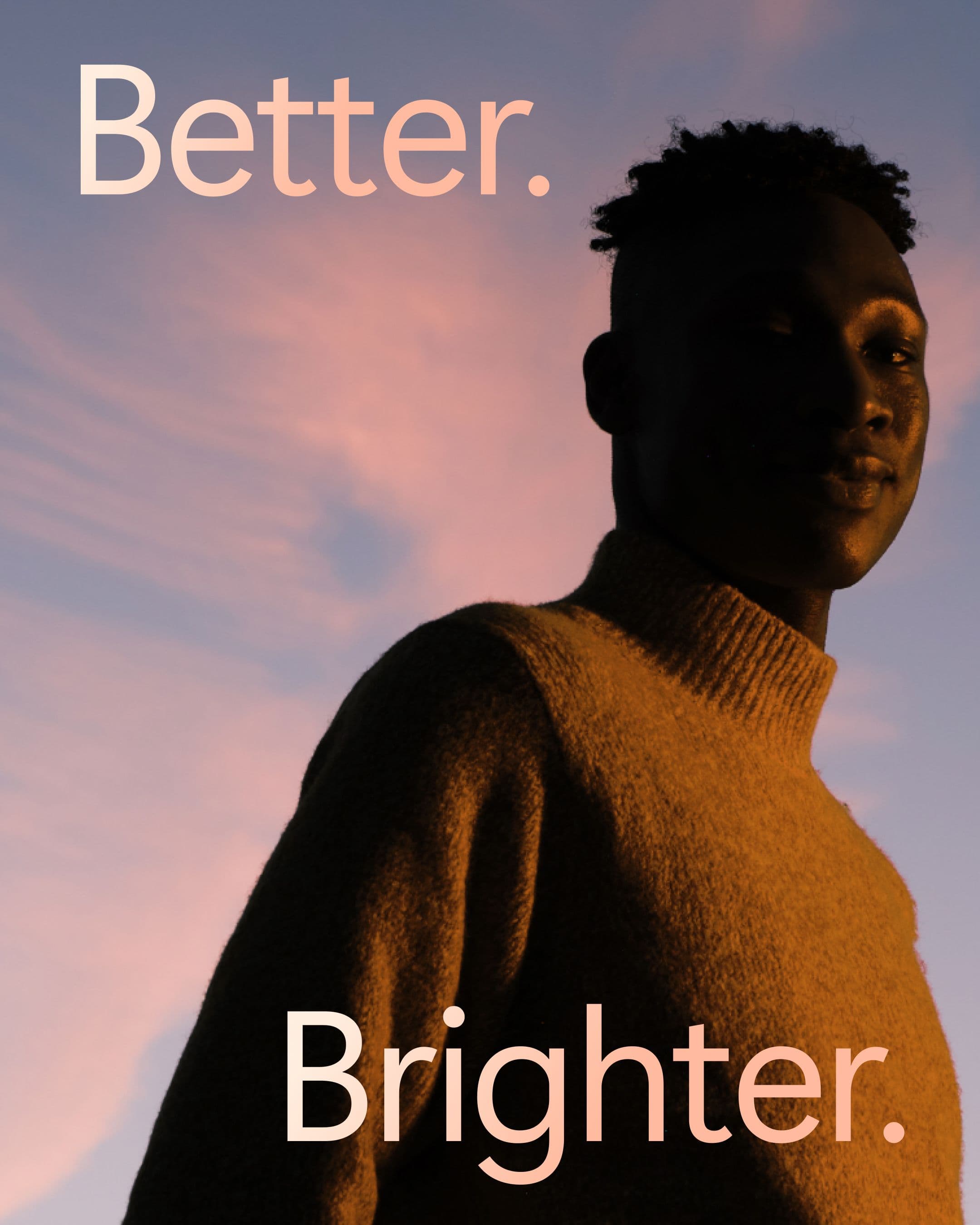A person stands against a pink sunset sky with the text “Better. and Brighter.”