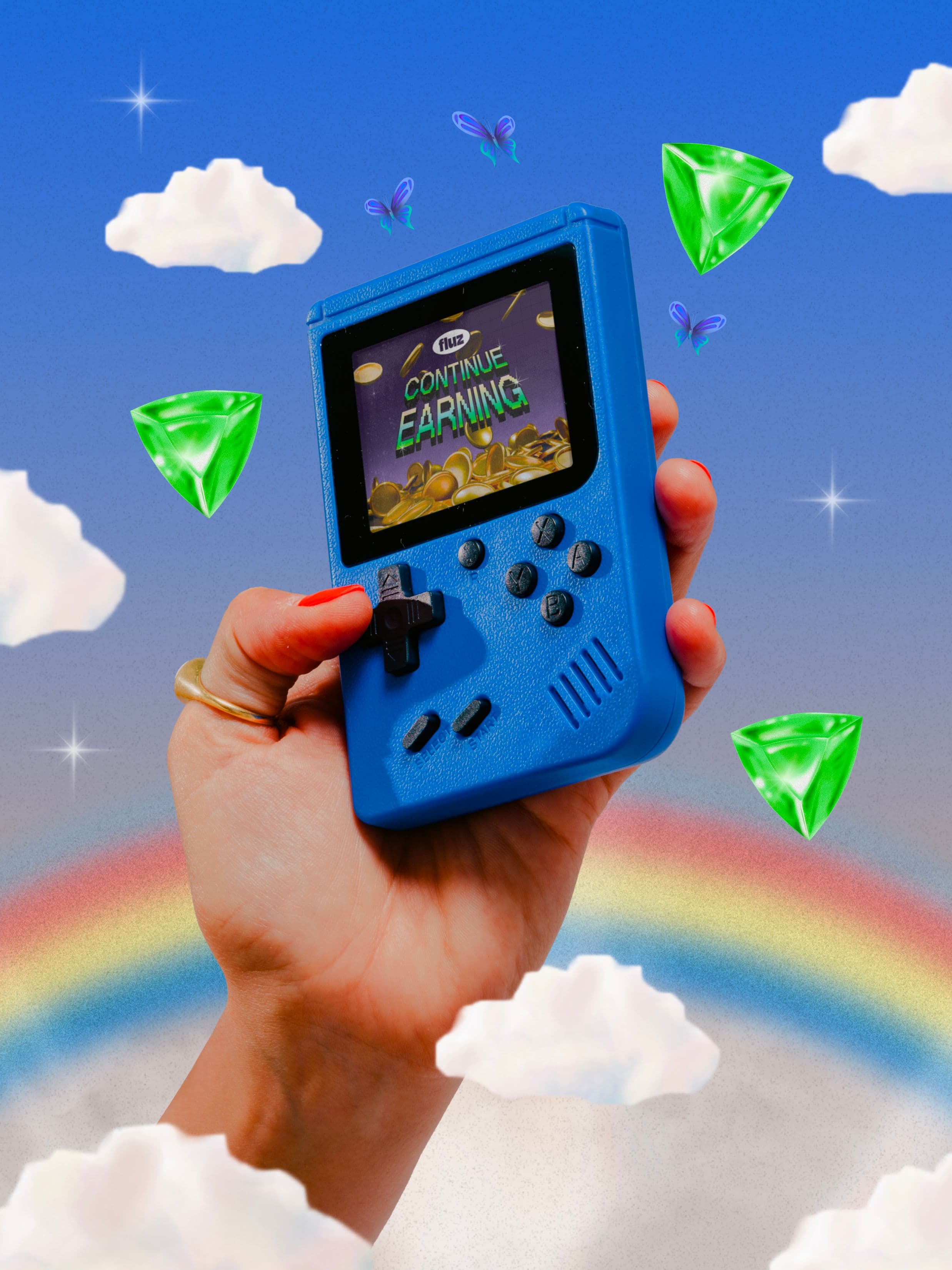 A hand holds a blue retro handheld gaming console. The screen reads “CONTINUE EARNING” with gold coins displayed. The background features clouds, green gems, butterflies, and a rainbow against a blue sky.