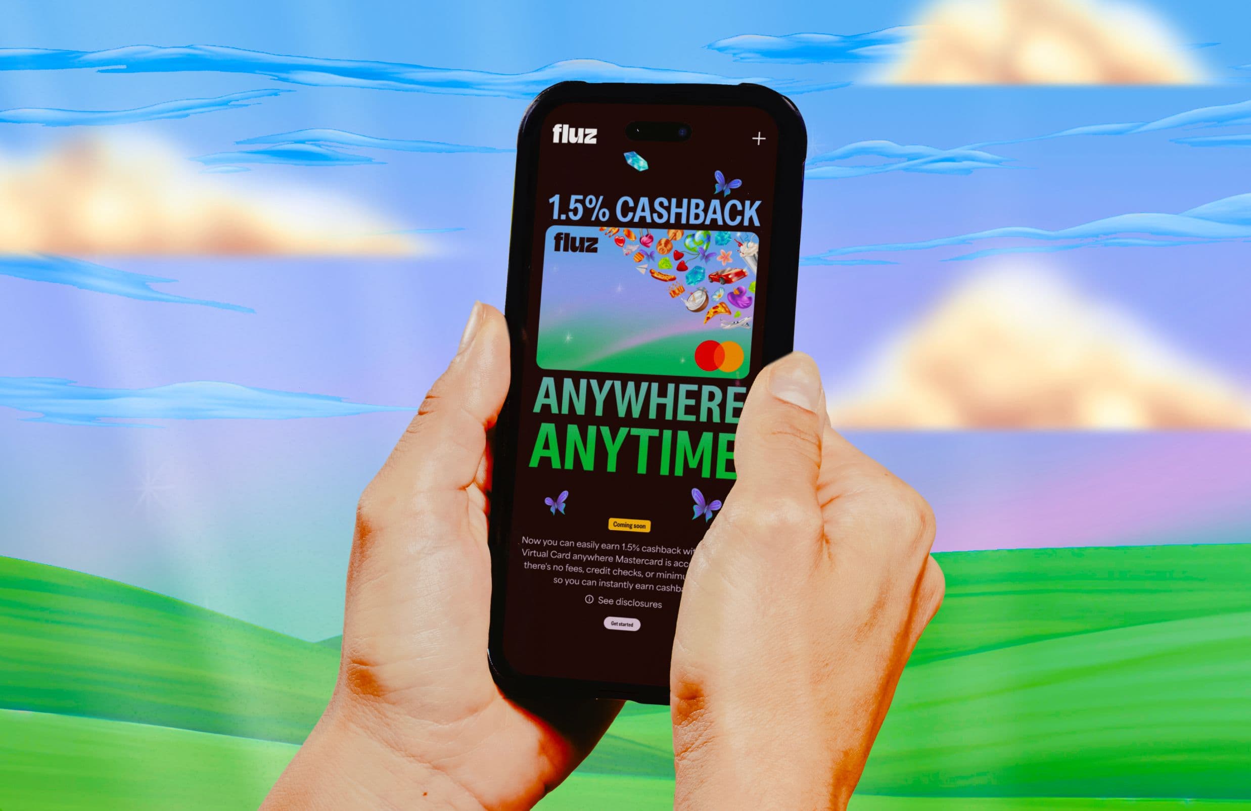 A person holds a smartphone displaying a Fluz app screen that reads “1.5% CASHBACK” and “ANYWHERE ANYTIME” .