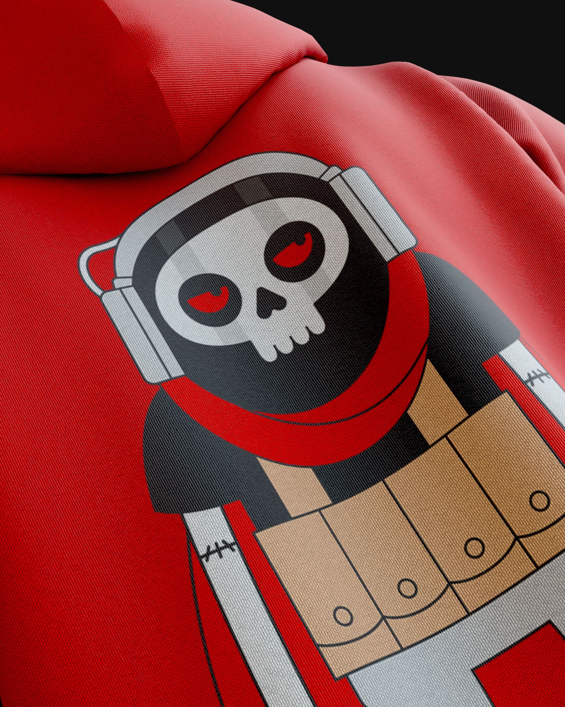 Close-up of a red hoodie featuring a cartoon graphic of a skull-headed character wearing headphones, a red scarf, and a utility vest.