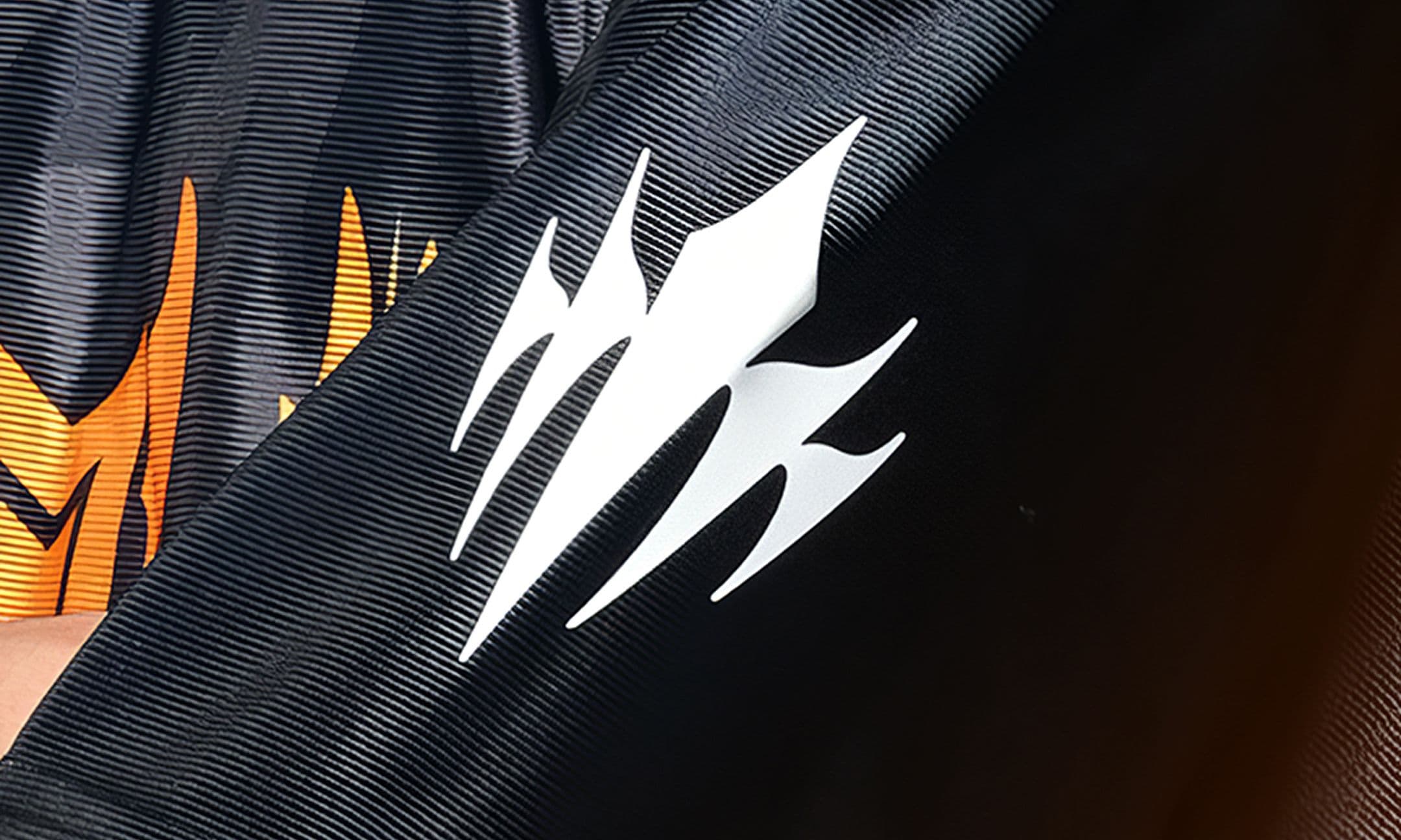 A close-up of a the Riot LCP logo on the sleeve of a shirt.